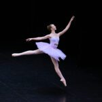 A girl doing ballet on stage