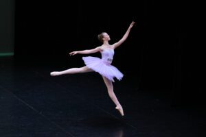 A girl doing ballet on stage