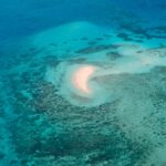 https://unsplash.com/photos/a-crescent-sandbar-in-a-vibrant-turquoise-ocean-with-reefs-Fcz03oK2KhU
