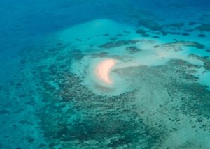 https://unsplash.com/photos/a-crescent-sandbar-in-a-vibrant-turquoise-ocean-with-reefs-Fcz03oK2KhU