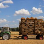 https://www.pexels.com/photo/tractor-towing-hay-bales-in-sunny-wheat-field-38890993/