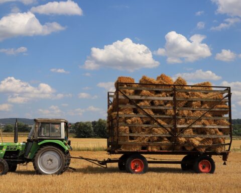 https://www.pexels.com/photo/tractor-towing-hay-bales-in-sunny-wheat-field-38890993/